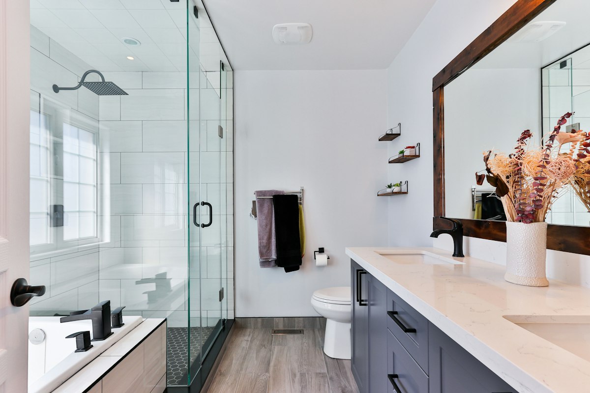 Bathroom with glass walk-in shower and vanity